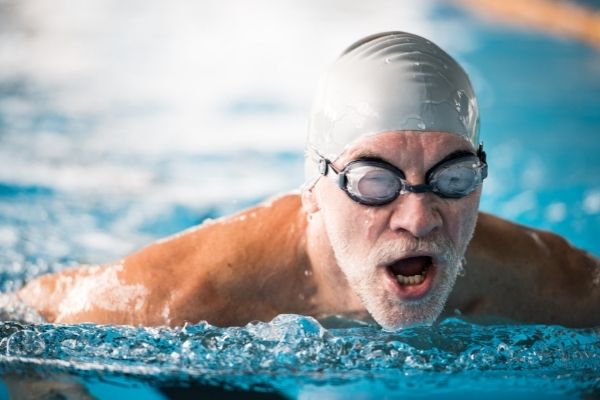 hombre de 50 años aprendiendo a nadar